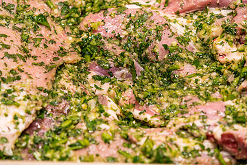 Image showing raw meats marinated in garlic olive oil parsley salt pepper