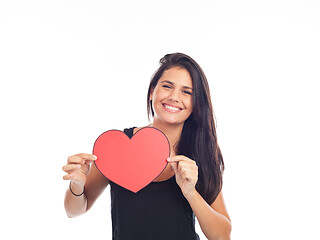 Image showing beautiful happy young woman who is holding a big red heart for v