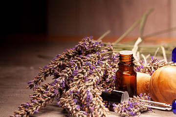 Image showing lavender mortar and pestle and bottles of essential oils for aro