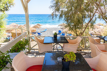 Image showing restaurant terrace in front of the beach in kamari on the island