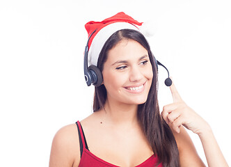 Image showing Christmas headset woman from telemarketing call center wearing red santa hat talking smiling isolated on white background.