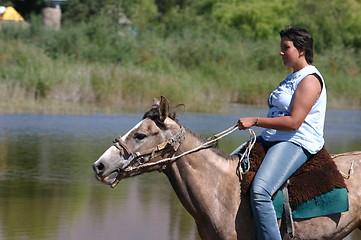 Image showing Girl riding on horse