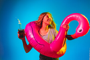 Image showing Beautiful woman in neon light isolated on blue studio background