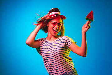 Image showing Beautiful woman in neon light isolated on blue studio background