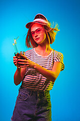 Image showing Beautiful woman in neon light isolated on blue studio background