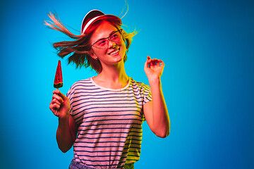 Image showing Beautiful woman in neon light isolated on blue studio background