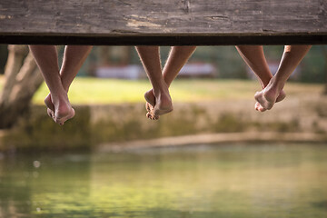 Image showing people sitting at wooden bridge