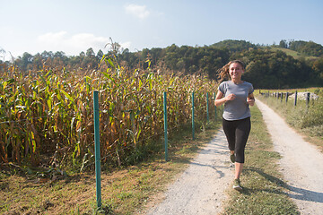 Image showing woman jogging along a country road