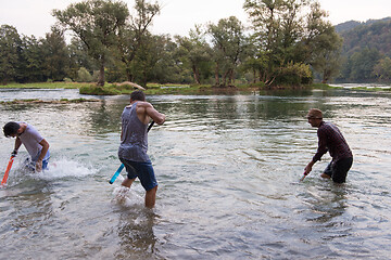 Image showing young men having fun with water guns