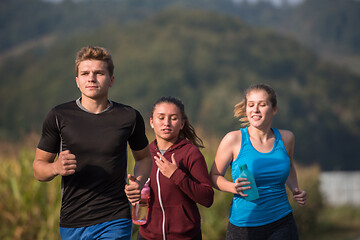 Image showing young people jogging on country road