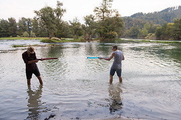 Image showing young men having fun with water guns