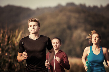 Image showing young people jogging on country road