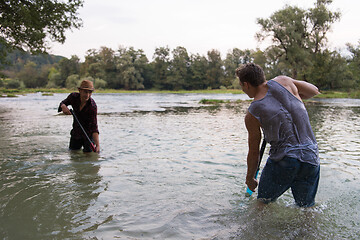 Image showing young men having fun with water guns