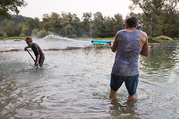 Image showing young men having fun with water guns