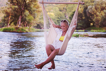 Image showing blonde woman resting on hammock