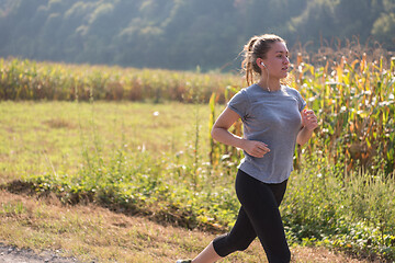 Image showing woman jogging along a country road