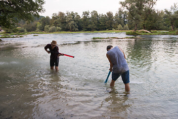 Image showing young men having fun with water guns