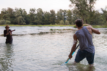 Image showing young men having fun with water guns