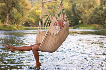 Image showing blonde woman resting on hammock