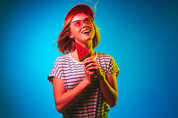 Image showing Beautiful woman in neon light isolated on blue studio background