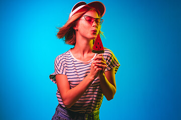 Image showing Beautiful woman in neon light isolated on blue studio background