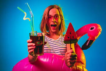 Image showing Beautiful woman in neon light isolated on blue studio background