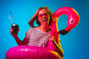 Image showing Beautiful woman in neon light isolated on blue studio background