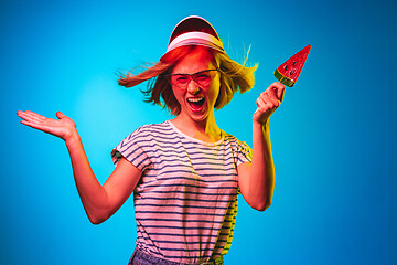 Image showing Beautiful woman in neon light isolated on blue studio background