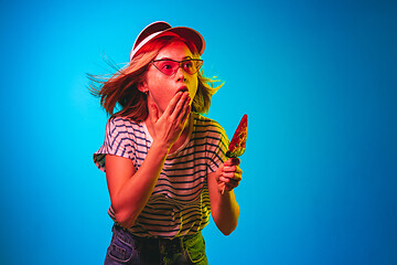 Image showing Beautiful woman in neon light isolated on blue studio background