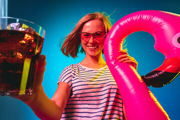 Image showing Beautiful woman in neon light isolated on blue studio background