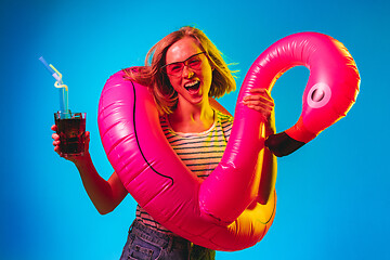 Image showing Beautiful woman in neon light isolated on blue studio background