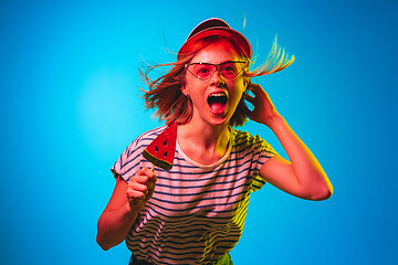 Image showing Beautiful woman in neon light isolated on blue studio background