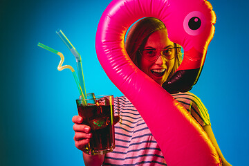 Image showing Beautiful woman in neon light isolated on blue studio background