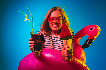 Image showing Beautiful woman in neon light isolated on blue studio background