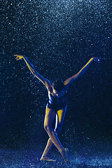 Image showing Two young female ballet dancers under water drops