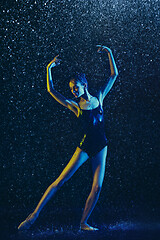 Image showing Two young female ballet dancers under water drops