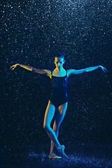 Image showing Two young female ballet dancers under water drops