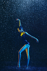 Image showing Two young female ballet dancers under water drops