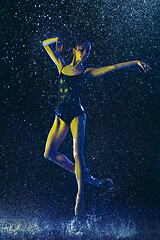 Image showing Two young female ballet dancers under water drops