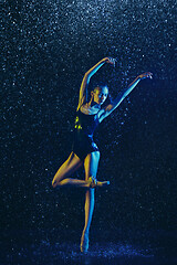 Image showing Two young female ballet dancers under water drops