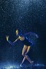 Image showing Two young female ballet dancers under water drops