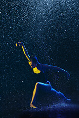 Image showing Two young female ballet dancers under water drops