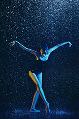 Image showing Two young female ballet dancers under water drops