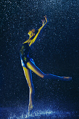 Image showing Two young female ballet dancers under water drops