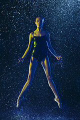 Image showing Two young female ballet dancers under water drops