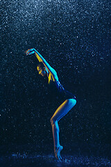 Image showing Two young female ballet dancers under water drops