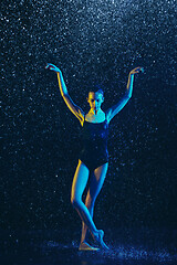 Image showing Two young female ballet dancers under water drops