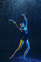 Image showing Two young female ballet dancers under water drops