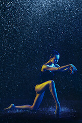 Image showing Two young female ballet dancers under water drops