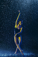 Image showing Two young female ballet dancers under water drops